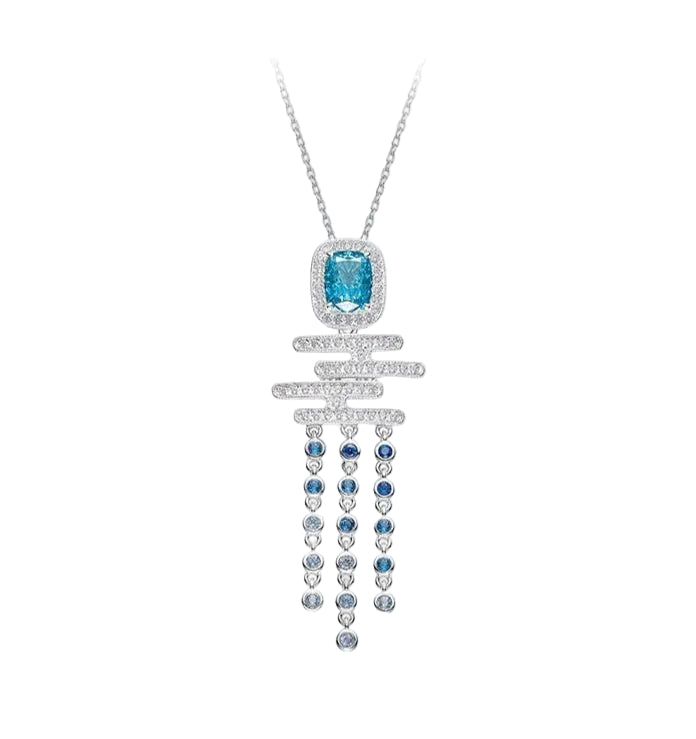 The Cadence Cascade Necklace by Gem Vivi showcases 18k white gold with a rectangular aquamarine, a horizontal bar accented with clear stones, and five dangling strands adorned with blue and clear gems.