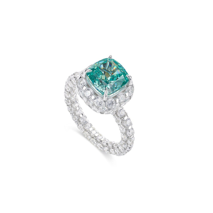The Glow Paraiba Ring by Gem Vivi features a vivid teal gemstone in an 18k white gold band, accented with round and rectangular diamonds—radiating diamondluxe elegance against a white backdrop.