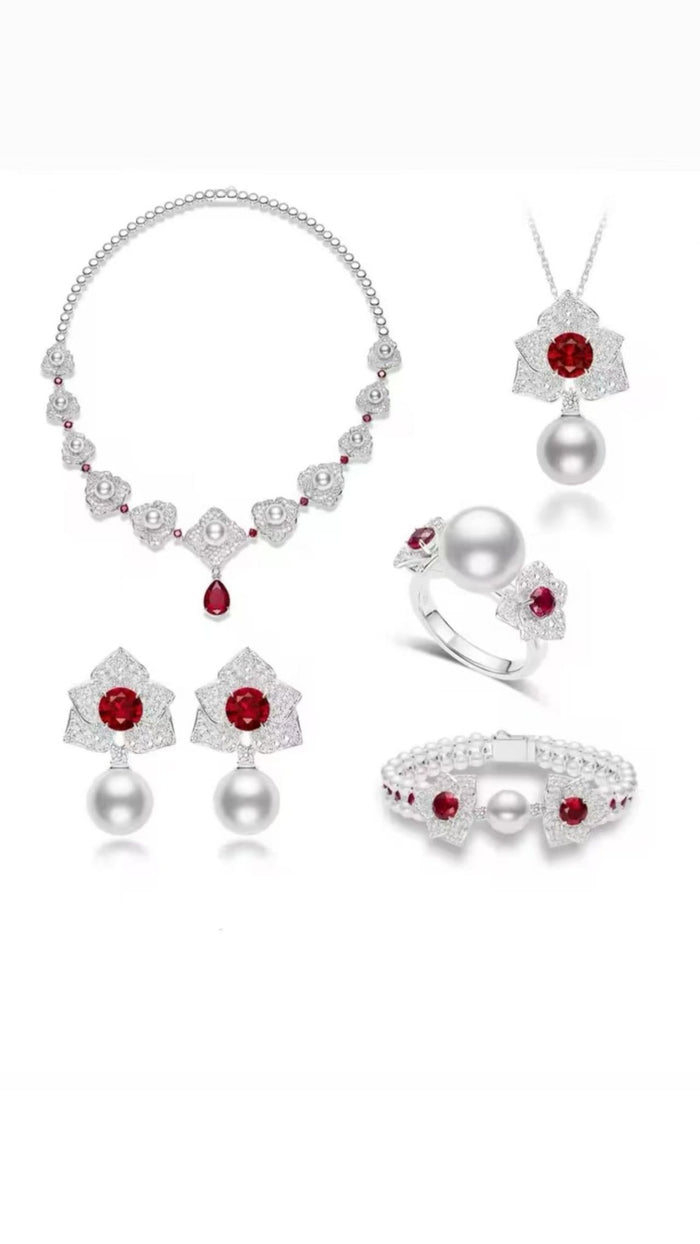 The Cascade Pearl Rosette Statement Necklace by Gem Vivi features pearls, diamonds, and a pear-cut ruby set in silver with 18k gold-finished details.