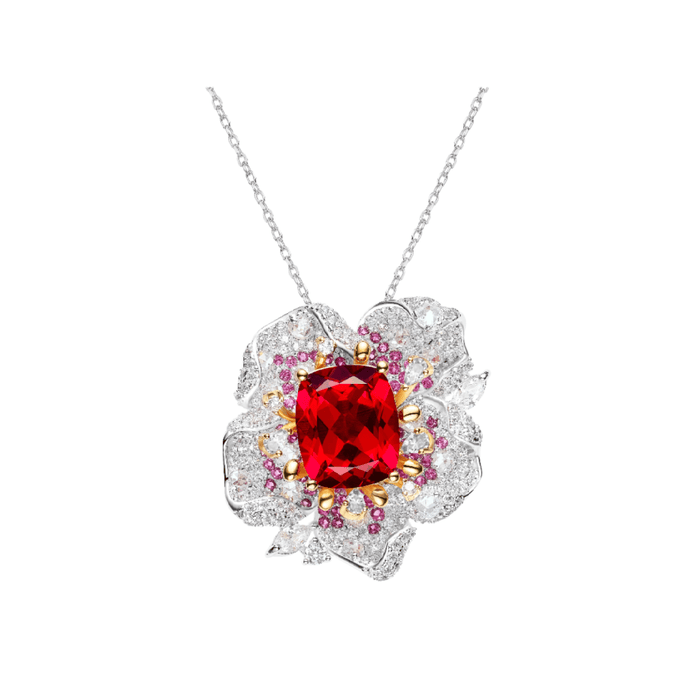 The Gem Vivi Cherish Floral Pendant Necklace features a large cushion cut lab-created ruby at the center of a flower-shaped silver pendant, accented with clear and pink stones.
