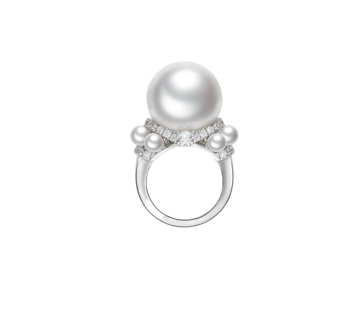 The Luminous Pearl Ring by Gem Vivi showcases a large Australian white shell pearl, flanked by smaller pearls and diamond accents, all set in 18k white gold.