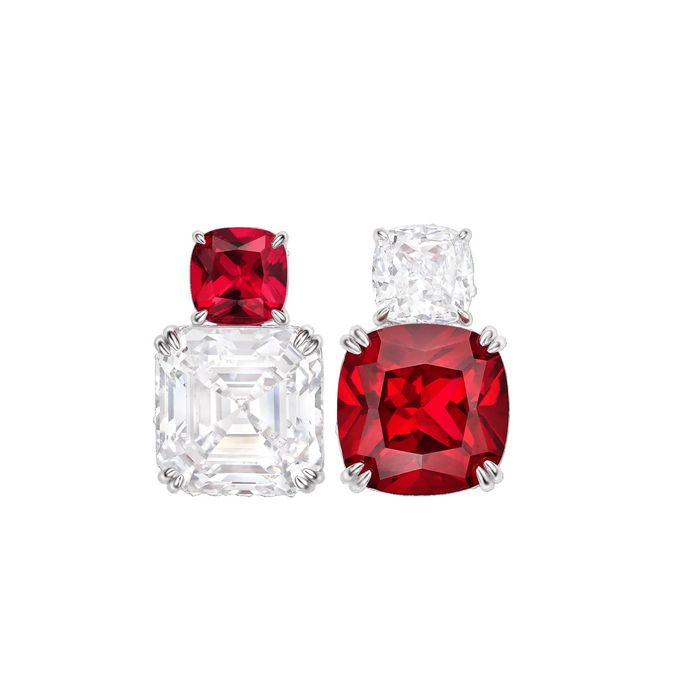 The Gem Vivi Red Ruby Duo Stud Earrings feature two mismatched studs: one with a small ruby above a cushion-cut clear stone, the other with a square clear stone above a round ruby, both set in 18k white gold prongs.