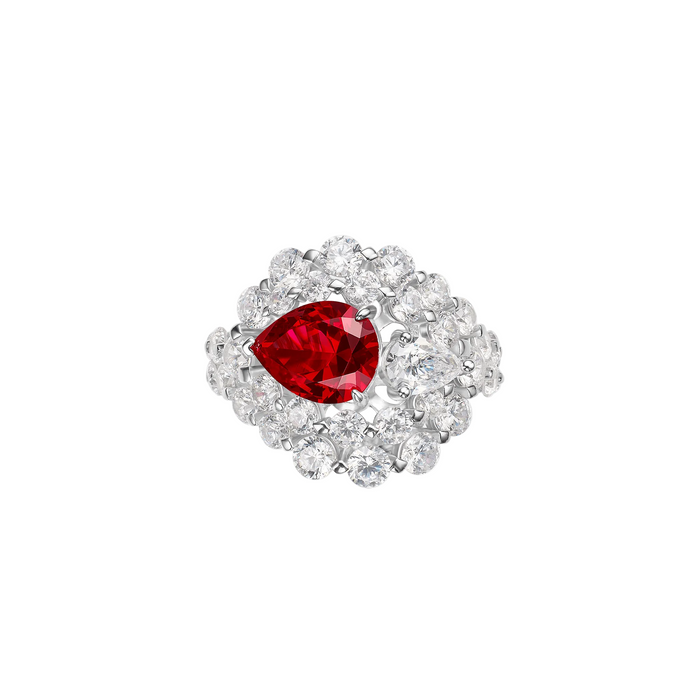 The Clara Ruby Glow Pear Ring by Gem Vivi features a pear-cut ruby at its center, encircled by two rows of round white diamonds on a polished 18k white gold band.