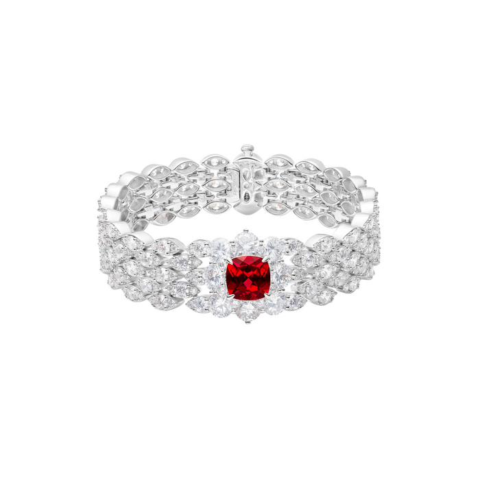 The Clara Ruby Petal Luxe Bracelet by Gem Vivi showcases a cushion cut lab-created ruby at the center, set in 18k white gold and accented with rows of clear round-cut gemstones.
