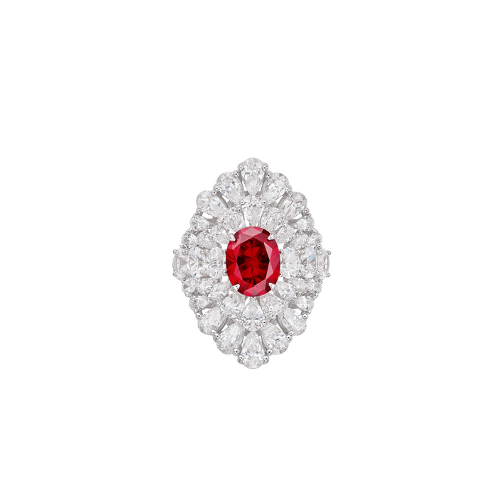 The Clara Ruby Radiance Ring by Gem Vivi showcases a large round lab-created ruby, encircled by clear pear-shaped and round diamonds in a symmetrical 18k white gold setting.