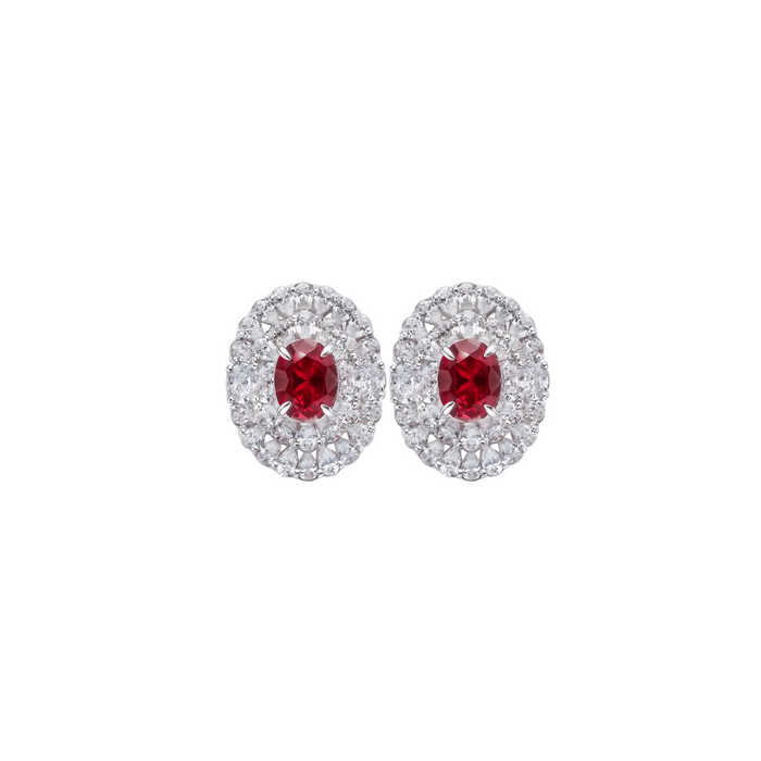 The Clara Ruby Radiance Stud Earrings by Gem Vivi feature oval lab-created rubies encircled by two rows of clear stones, all set in 18k white gold.