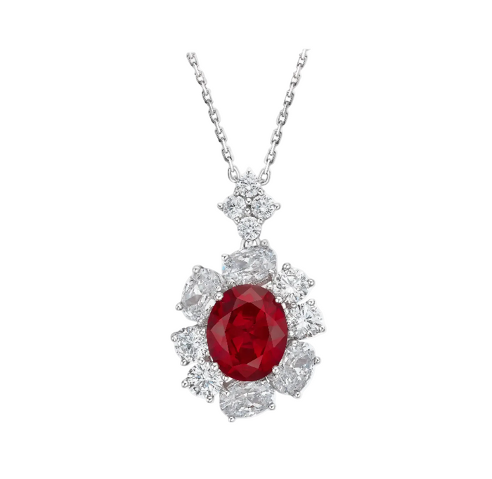 The Gem Vivi Cynthia Ruby Spark Pendant Necklace features a silver chain with an oval-cut lab created ruby pendant, encircled by clear faceted gemstones in a floral design.