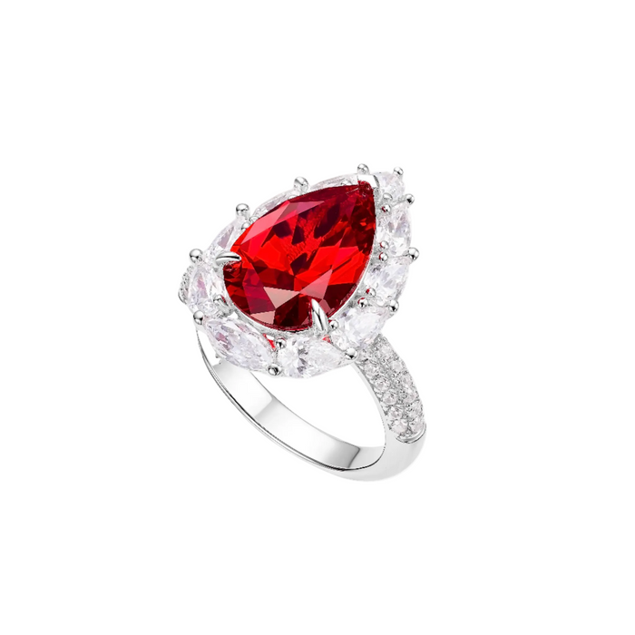 The Gem Vivi Caroline Pear Ruby Radiant Halo Ring showcases a striking pear-cut ruby center, encircled by clear stones and additional accents on the 18k white gold band.