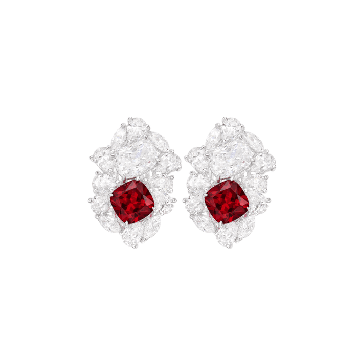 The Calista Bloom Ruby Stud Earrings by Gem Vivi feature cushion cut lab-created rubies, encircled by faceted clear gems in a floral design, all set in 18k white gold.
