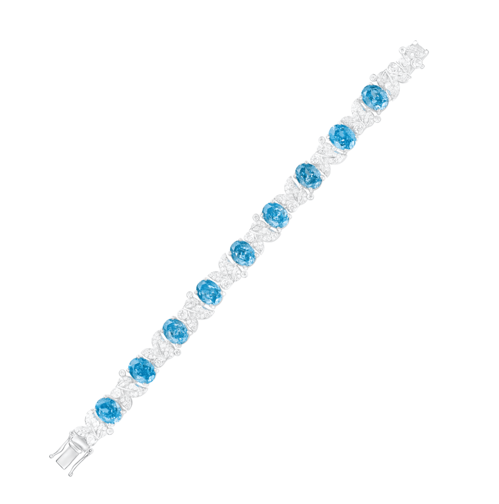 The Gem Vivi Aquamarine Oval Leaf Tennis Bracelet features alternating ocean blue and clear gemstones set in 18k white gold, arranged in a single row with a secure clasp.