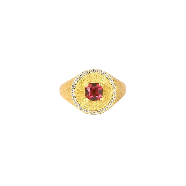 The Ivy Signet Ring by Gem Vivi features 18K yellow gold with a cushion-cut red center stone, surrounded by small clear stones, shown on a white background.