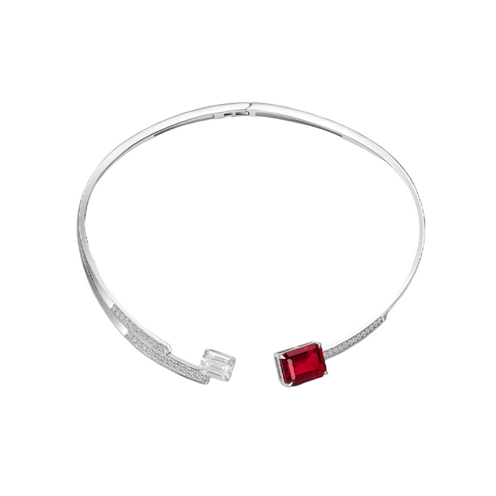 The Crimson Glow Ruby Choker Necklace by Gem Vivi is a silver open choker featuring an emerald-cut lab-created ruby on one end and a clear gemstone on the other, each in minimalist mounts.