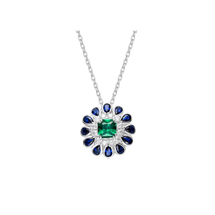 The Blossom Halo Necklace by Gem Vivi features a silver chain with a square green gemstone pendant, surrounded by diamonds and blue teardrop stones, evoking the elegance of a floral design.