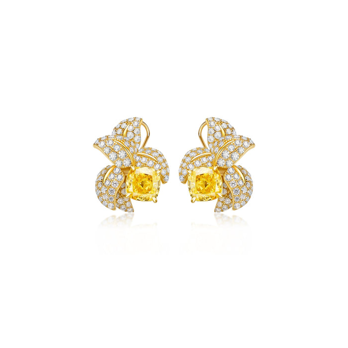 The Bloom Golden Stud Earrings by Gem Vivi feature floral 18k yellow gold, cushion-cut centers inspired by canary yellow Vivi DiamondLuxe, and petals adorned with clear crystals.