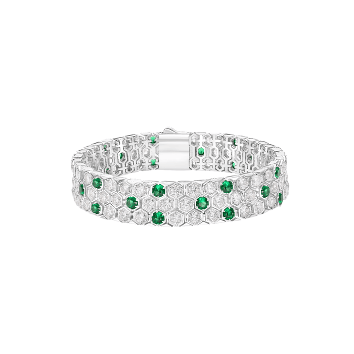 The Emerald Imperial Garden Bracelet by Gem Vivi is a vintage-inspired sterling silver piece with a geometric honeycomb pattern, featuring clear and green gemstones.