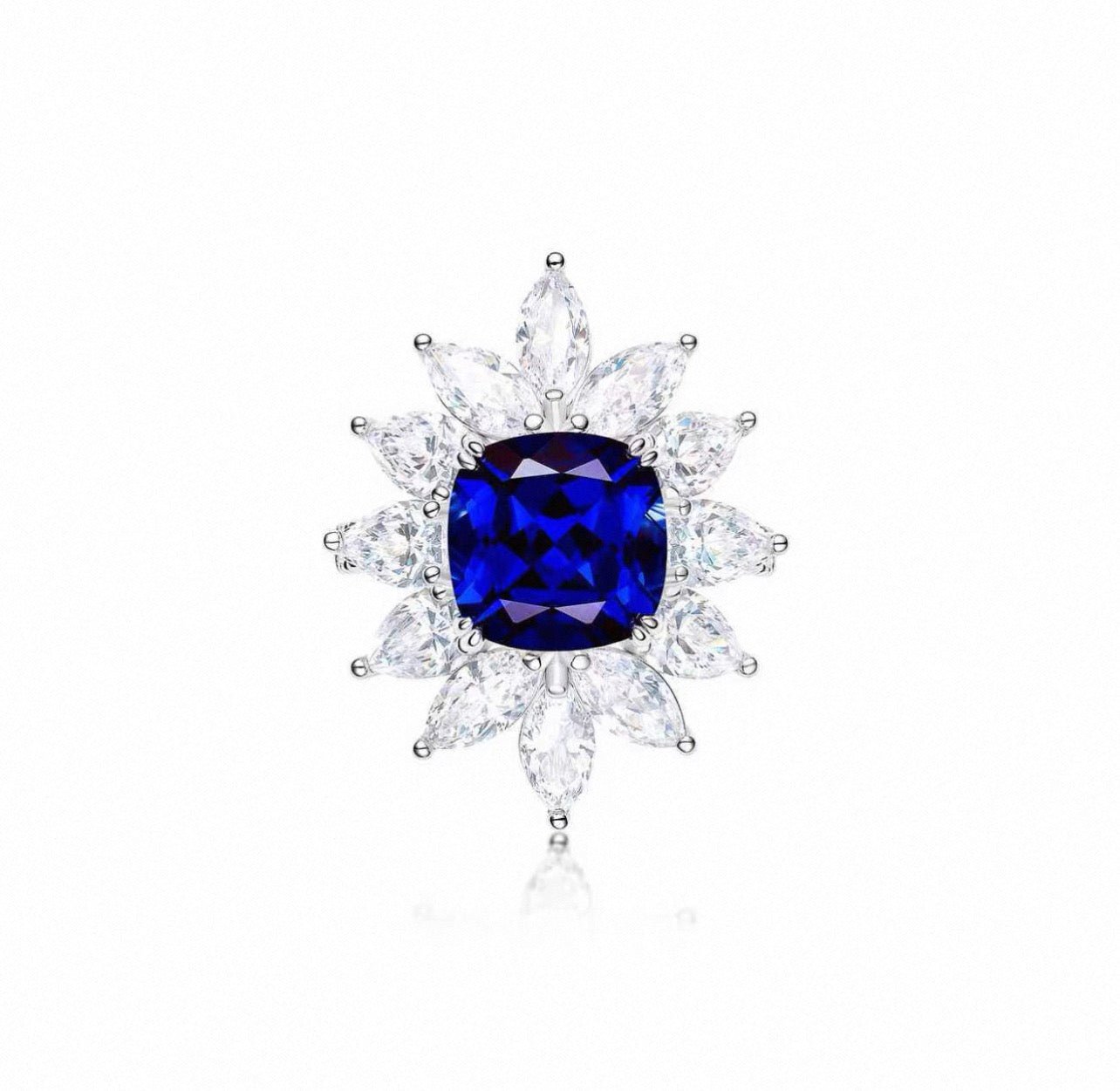 The Gem Vivi Midnight Starburst Sapphire ring showcases a large cushion-cut sapphire center, framed by two rows of marquise-cut clear stones in a striking floral sunburst design.