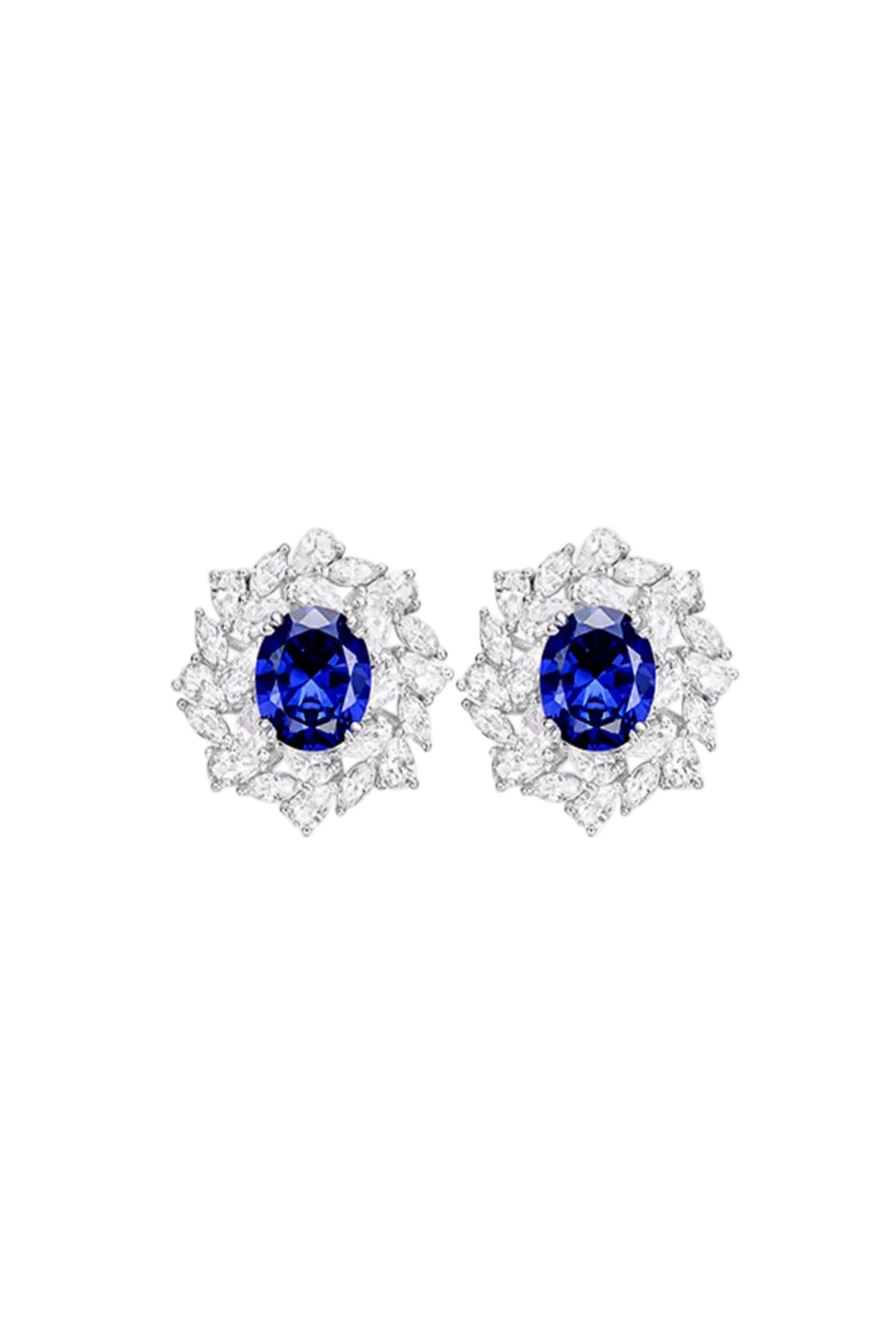 The Blue Midnight Royale Marquise Cluster Studs by Gem Vivi showcase blue gemstones and clear diamonds in a marquise cluster design, set in 18k white gold, all displayed against a white background.