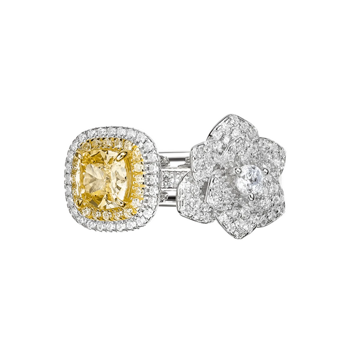 The Gem Vivi Petal Charm Ring Set features a cushion-cut yellow gemstone ring in 18k white gold, with a diamond halo and a matching band adorned with diamond-studded petal motifs.