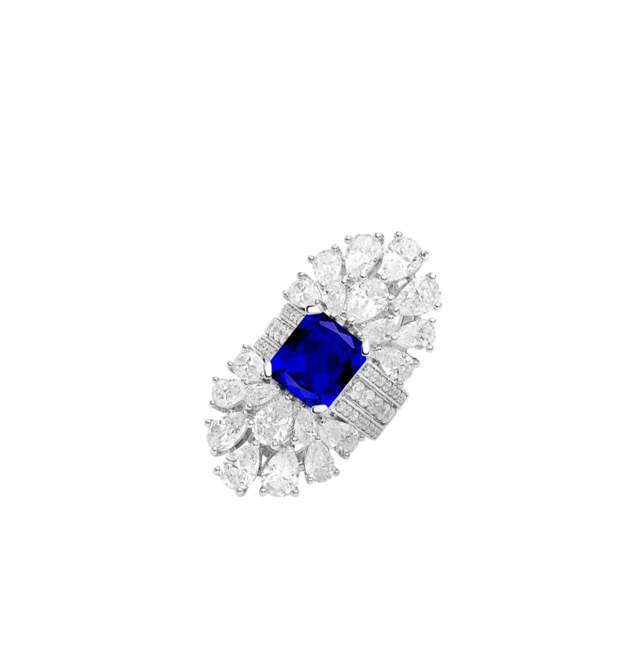 The Gem Vivi Blue Radiant Cushion-Cut Sapphire Halo Ring showcases a striking lab-created blue center stone, framed by pear-shaped clear stones and set in an elegant 18k white gold band.