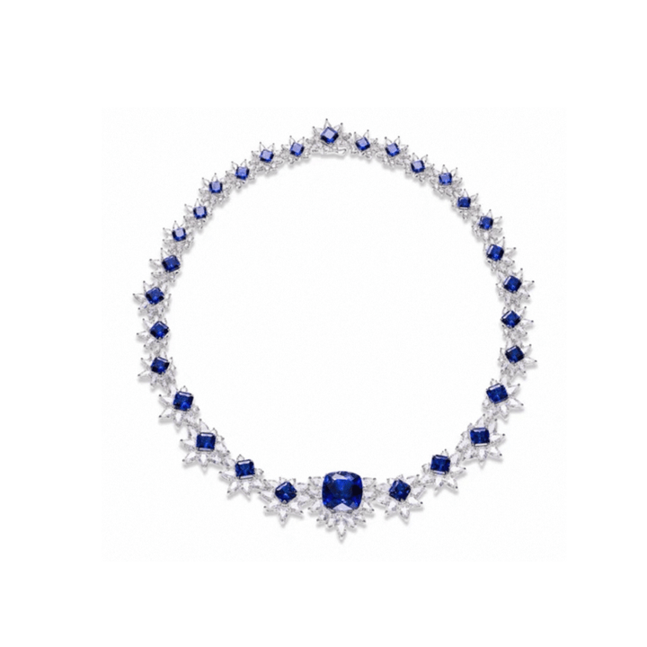 The Gem Vivi Midnight Starburst Necklace features alternating blue sapphires and clear diamonds in a symmetrical 18k white gold setting, highlighted by a central cushion cut sapphire.