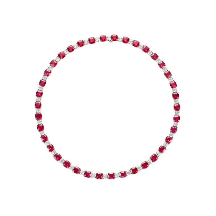 The Calla Glow Ruby Statement Necklace by Gem Vivi is a circular tennis necklace with alternating lab-created rubies and clear gemstones in a symmetrical pattern.
