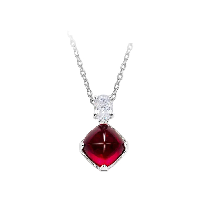 The Radiance Sugar-Loaf Pendant Necklace by Gem Vivi features a clear oval gemstone above a cushion-cut deep red gem in a four-prong setting, adding classic charm to any look.