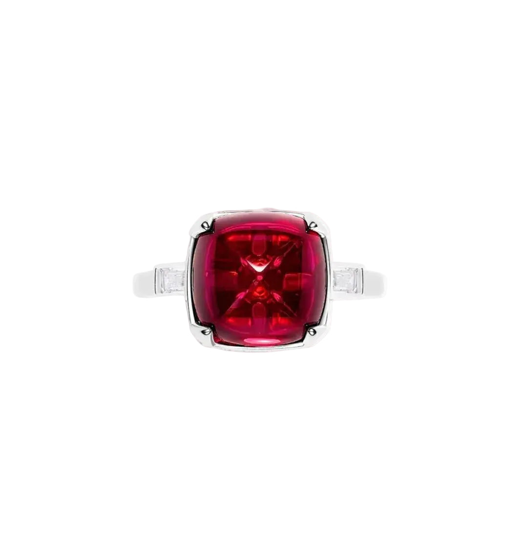 The Chantal Radiance Sugar-loaf Ring by Gem Vivi showcases a striking lab-created ruby set in 18k white gold with rectangular clear side stones and a bold cushion-cut red centerpiece.