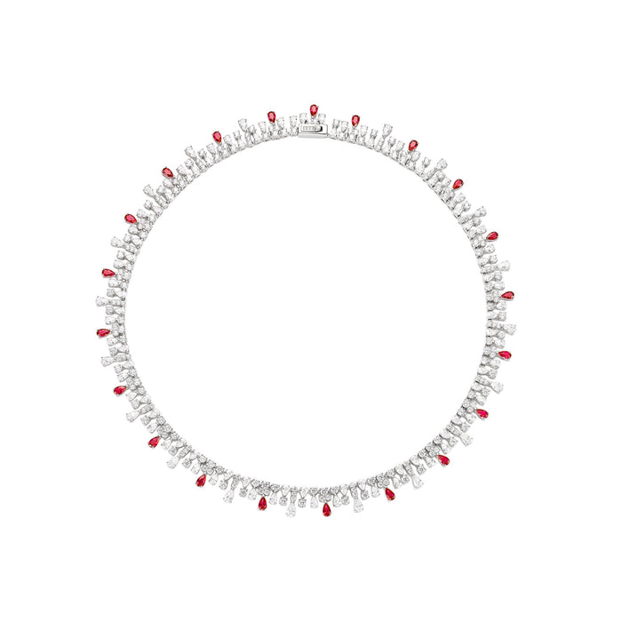 The Cambria Ruby Spark Drop Necklace by Gem Vivi showcases alternating clusters of clear and red gemstones set in a circular pattern on an 18k white gold band.