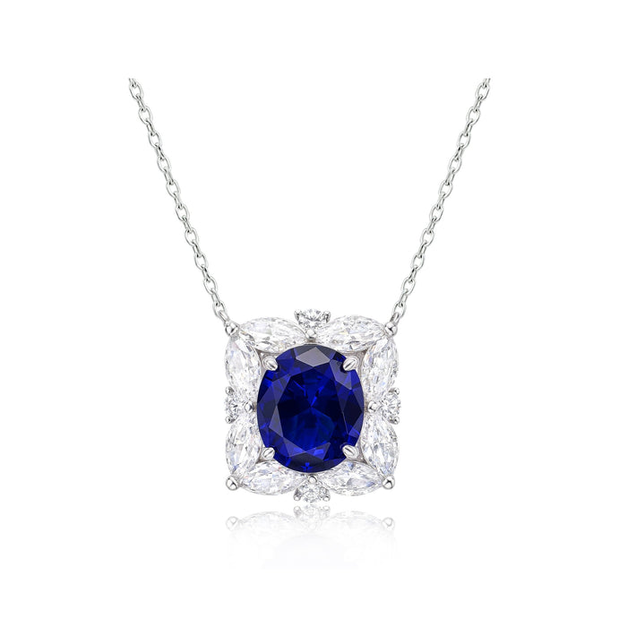 The Gem Vivi Blue Sapphire Bloom Halo Pendant Necklace features a central oval lab-created sapphire accented by four marquise-cut clear stones and round accents in a floral-inspired silver setting.
