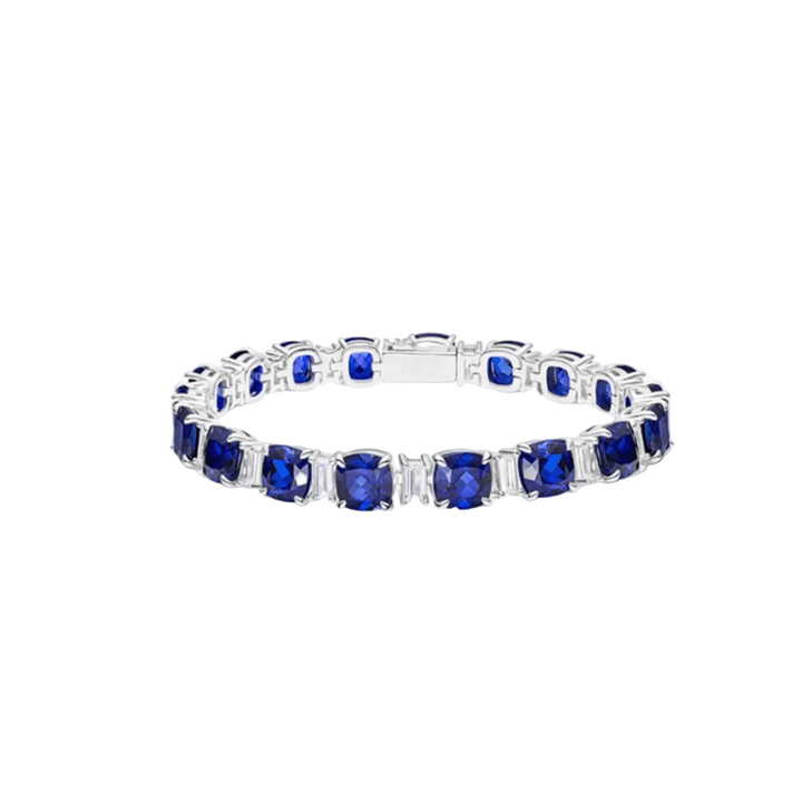 The Gem Vivi Blue Sapphire Tennis Bracelet features lab-created cushion-cut sapphires in a continuous silver band.