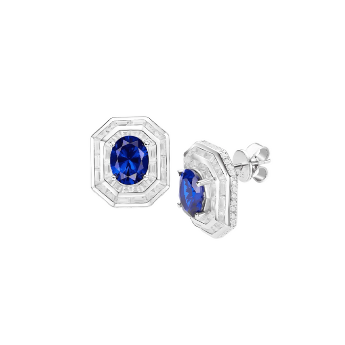 Blue Sapphire Halo Studs Earrings by Gem Vivi: 18k white gold studs with a central lab-created sapphire, encircled by a geometric halo of clear stones.