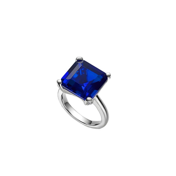 The Gem Vivi Blue Sapphire Square Ring features a large, square-cut lab-created sapphire in a four-prong setting, showcased on a white background.
