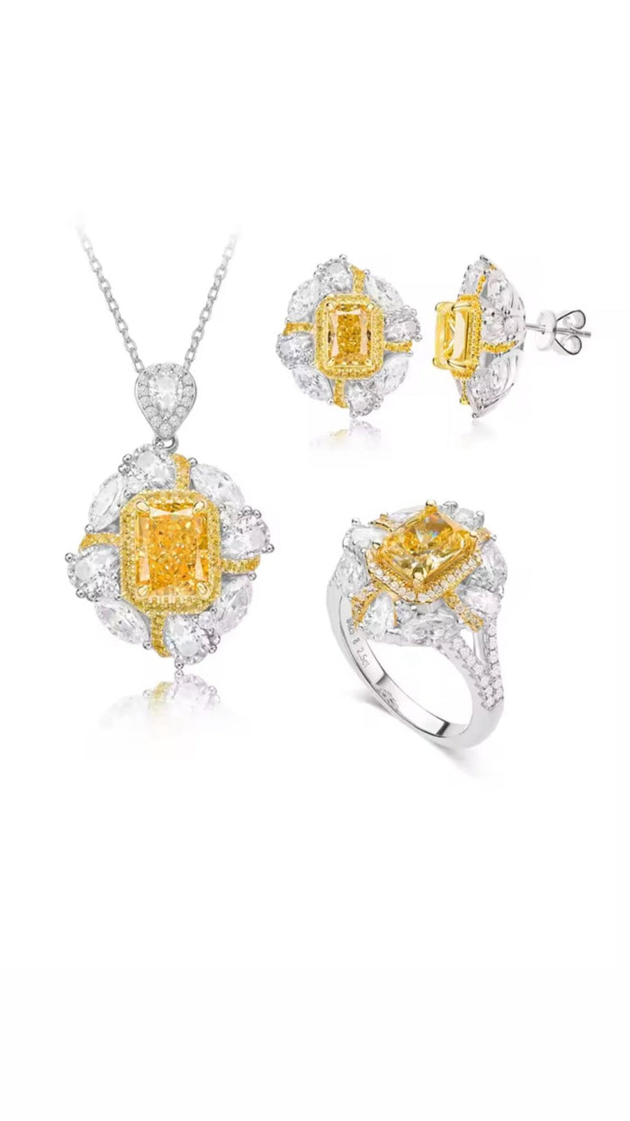 Gem Vivi’s Canary Yellow Square Stone Dangle Earrings feature emerald-cut yellow stones surrounded by clear gems, set in 18k white gold.